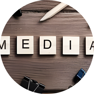 Scrabble tiles spelling "MEDIAL" on a wooden surface surrounded by office supplies.